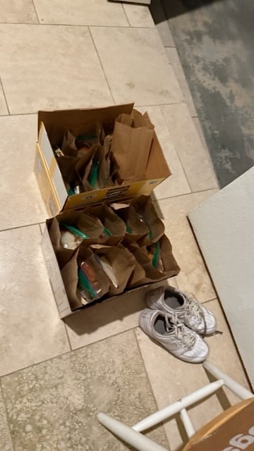 Bags packed with healthy groceries and green produce