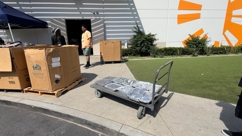 Meal trays on a flatbed cart outside a donation facility