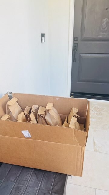 Box of donation bags ready for delivery at the door