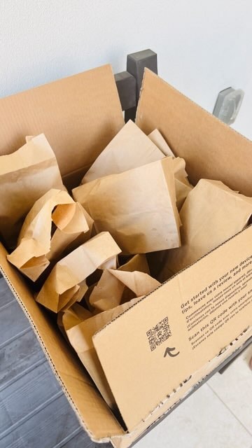 Box of packed donation bags on the porch